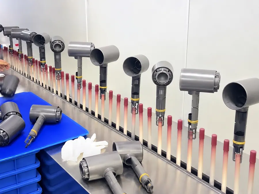High-speed hotel hair dryers moving through factory production
