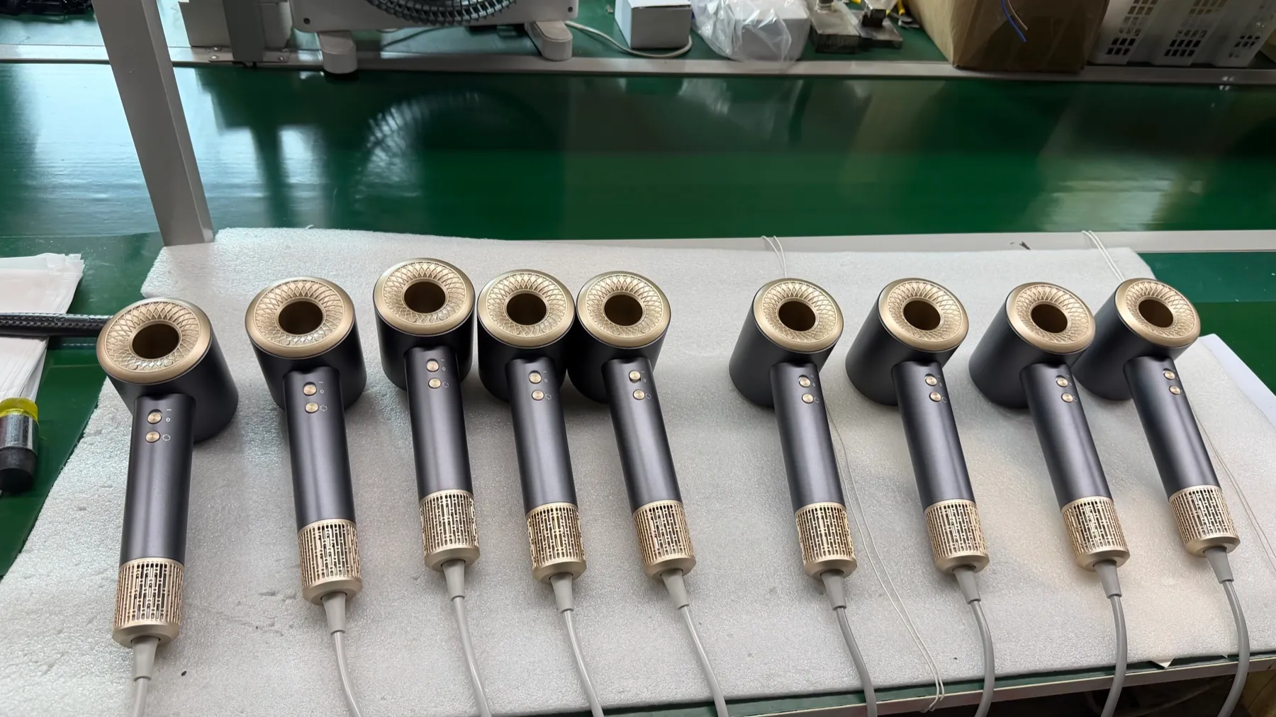 Gray H21 high-speed hair dryers lined up on an assembly line