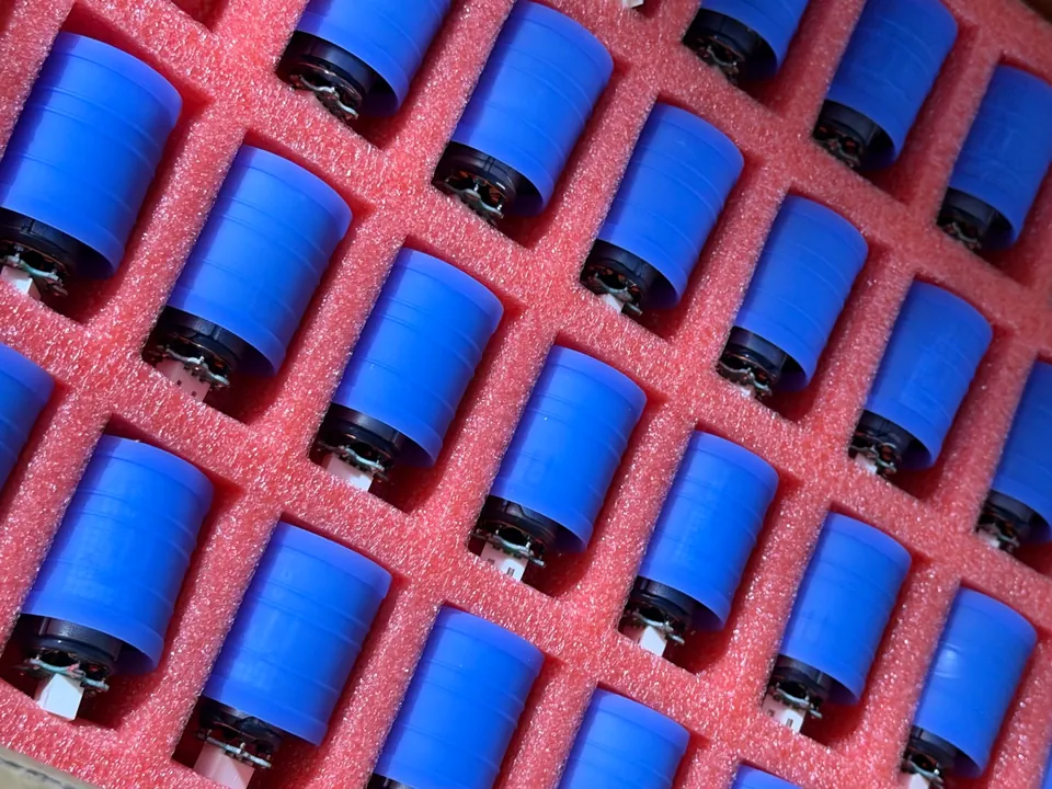 Blue high-speed hair dryer motor components arranged in protective trays